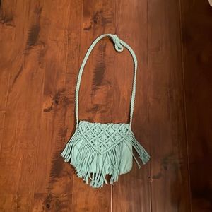 Teal macramé purse with braided strap.
